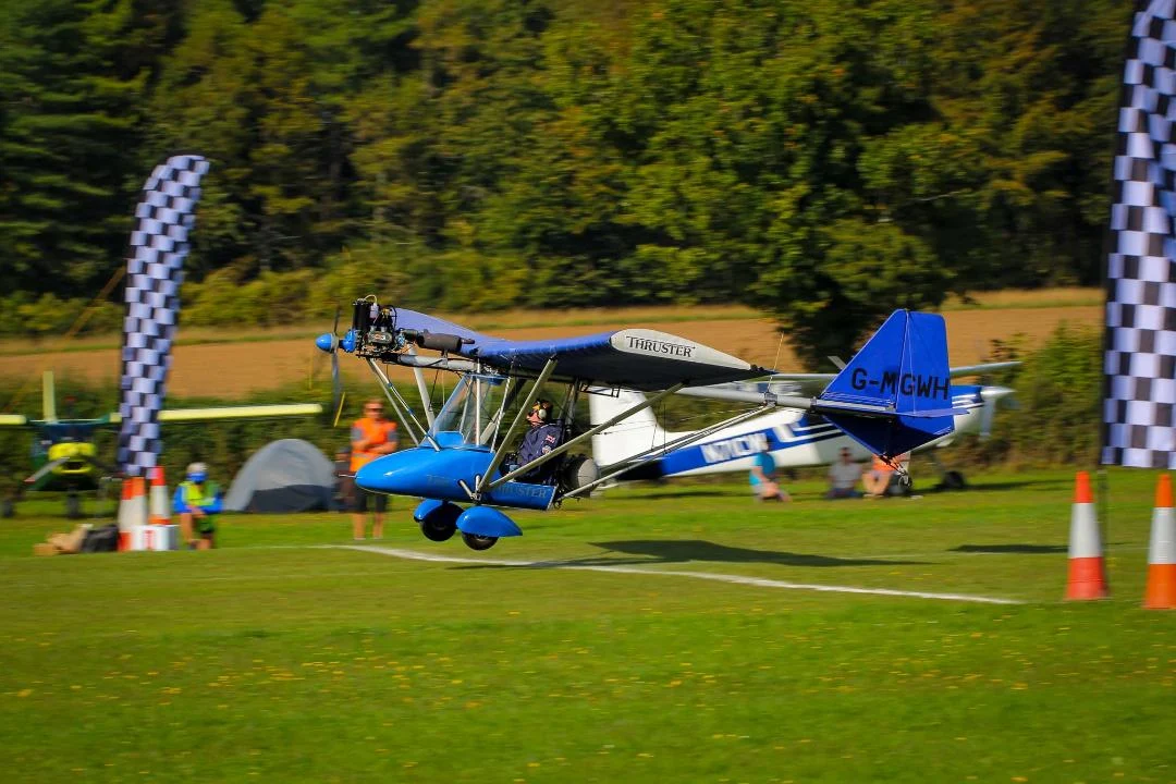 Stock Thruster T300 crossing the marked competition line between chequered flags